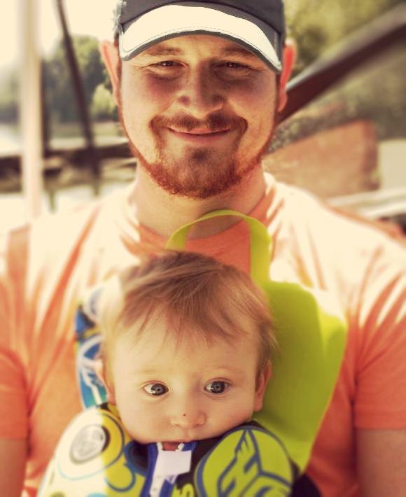 Scott with his baby in a carrier